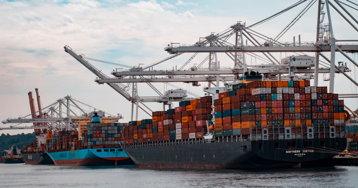 Shipping containers stacked at a busy port
